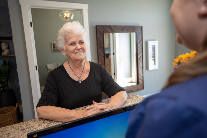 office manager welcoming dental patient