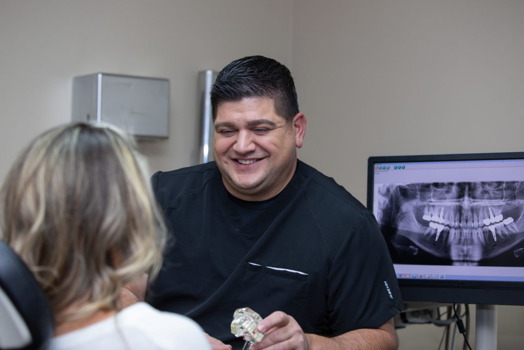 dentist showing patient x-rays