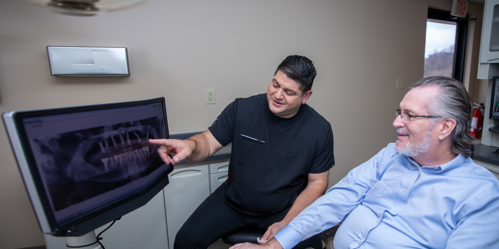 Patient learning about fixed dental bridges