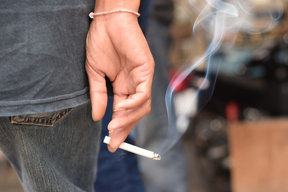 lit cigarette being held