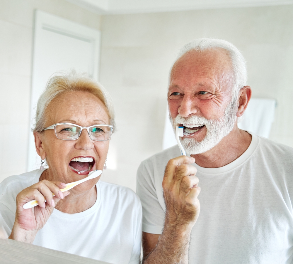 senior couple couple brushes teeth