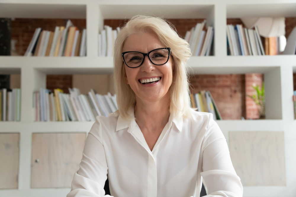 white haired older woman smiles
