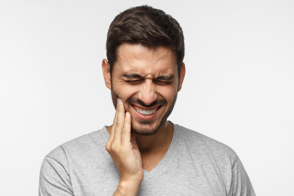 young man has tooth ache