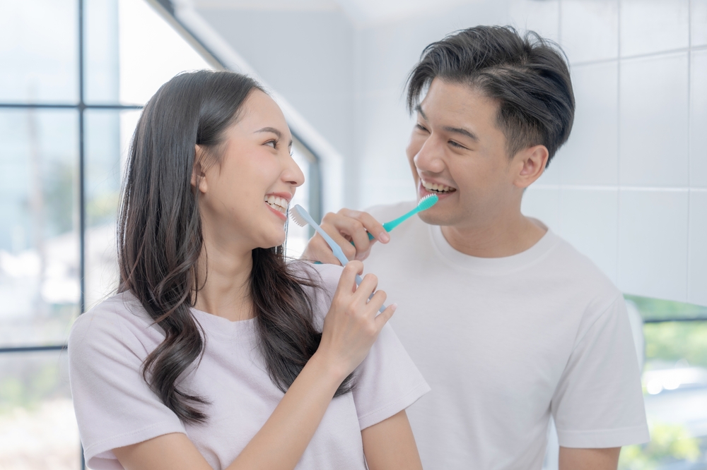 couple brushing teeth