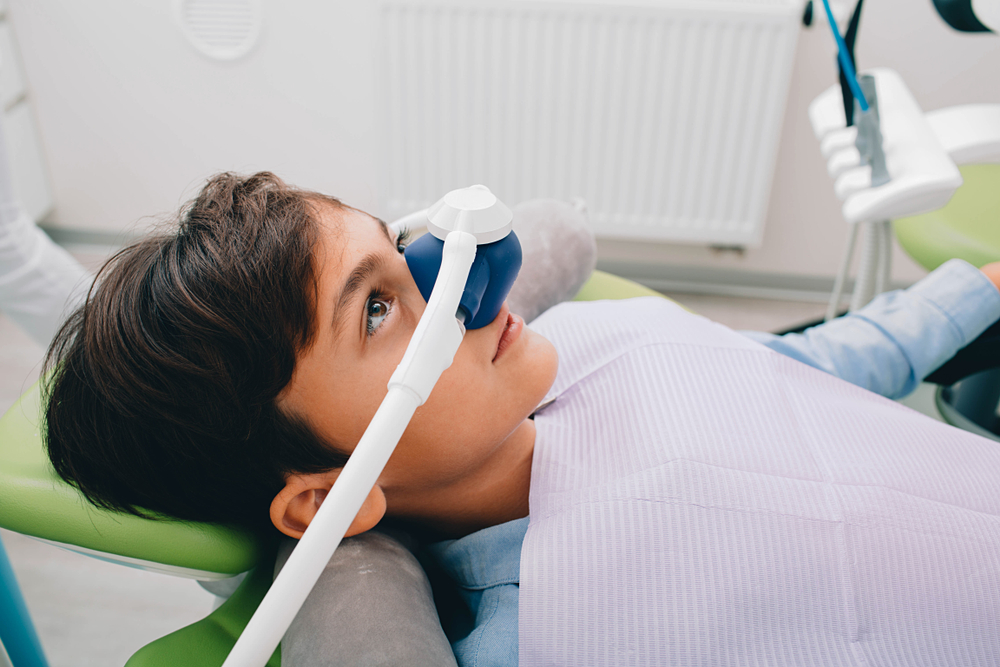 little boy wearing nasal nitrous oxide mask