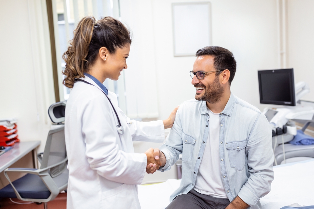 man shakes dentists' hand