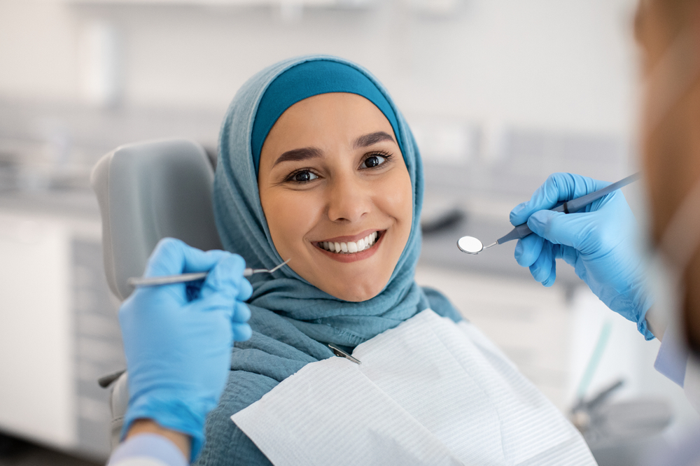 young woman wearing hijab at dental visit