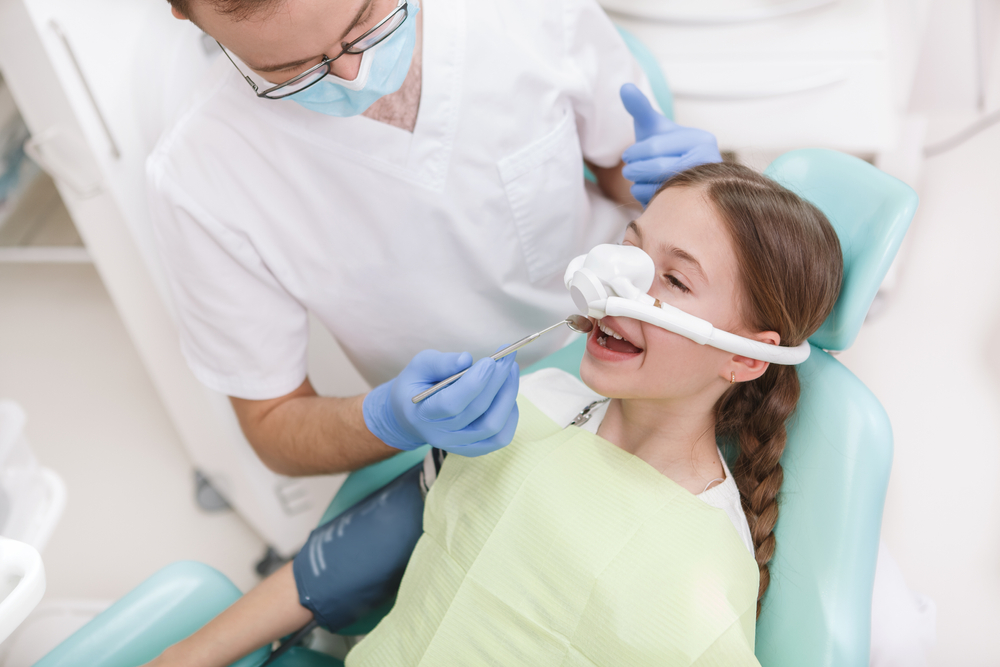 child sedated with nitrous oxide has dental exam
