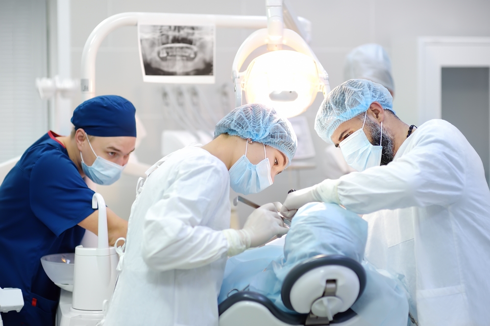 dental professionals perform procedure