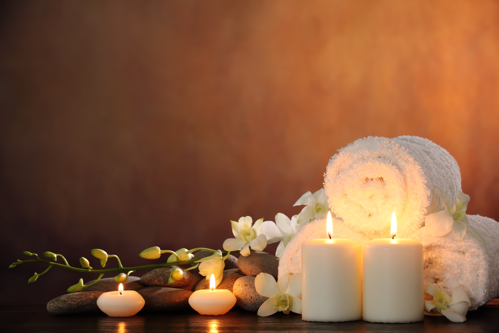 spa towels next to lit candles