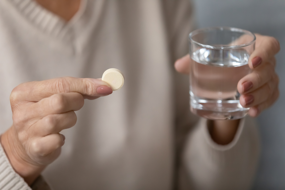 pill and water in glass
