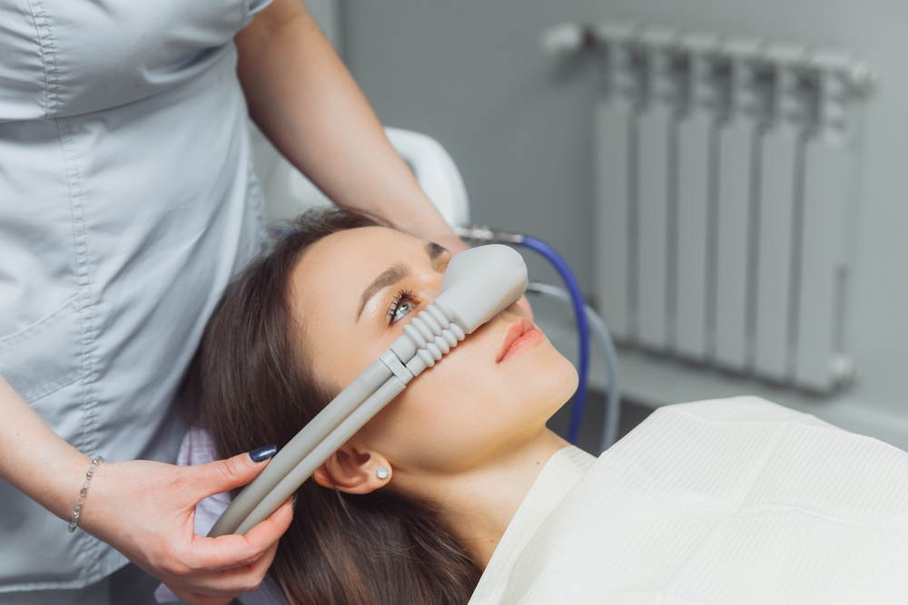 dentist puts sedation mask on patient
