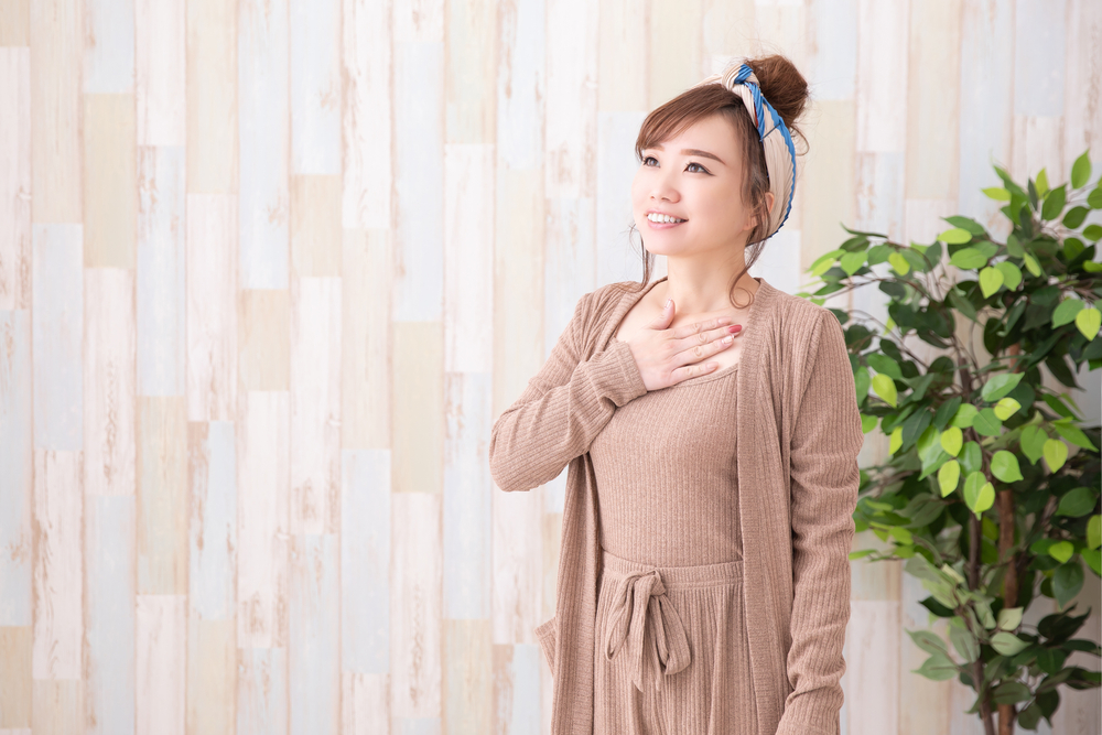 woman in brown lounge wear breathes deeply